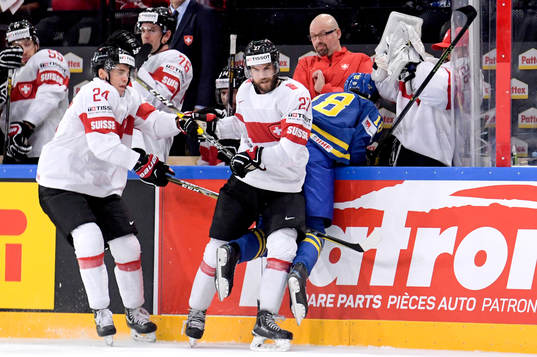 Schweiz Dominik Schlumpf tacklar in Sveriges Dennis