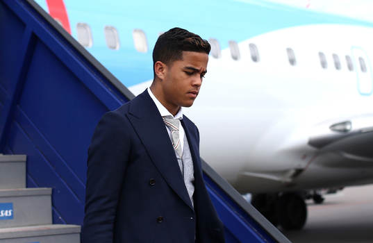 Justin Kluivert of Ajax arrives with team mates