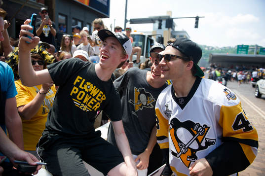 Pittsburgh Penguins' Connor Sheary takes a selfie with a fan