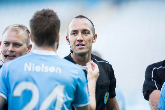 Domare Kaspar Sjöberg hälsar på spelare