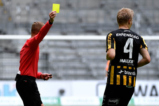 Domare Glenn Nyberg ger Häckens Juhani Ojala gult kort