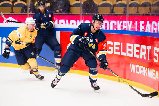 Esbjerg Phillip Bruggisser chases HV71 Pierre Engvall