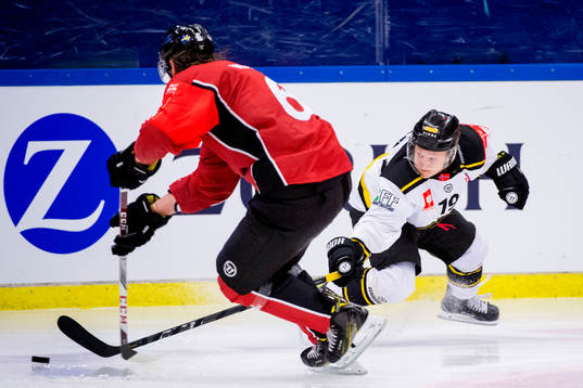 Magnus Hoff of Magnus Hoff reaches for the puck from Stefan
