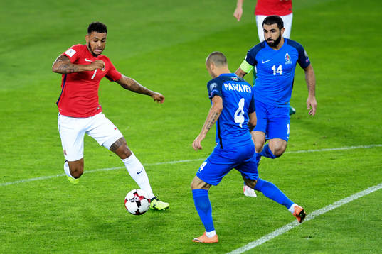Joshua King of Norway compete for the ball against Pavlo