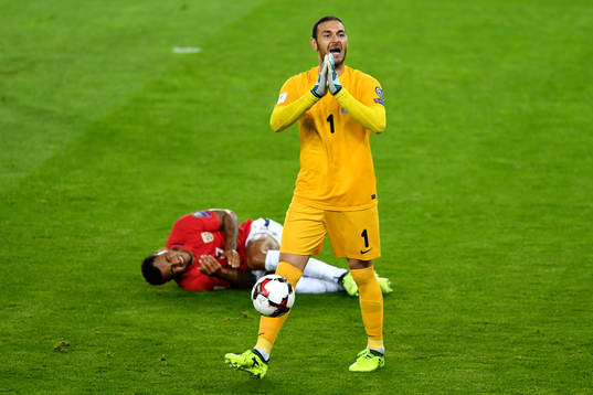 Joshua King of Norway lies down while goalkeeper Kamran