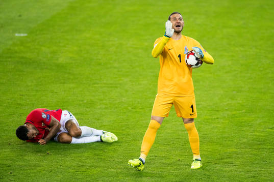 Joshua King of Norway lies down while goalkeeper Kamran