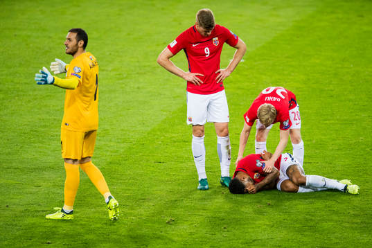 Joshua King lies down next to Alexander Sørloth and Mats