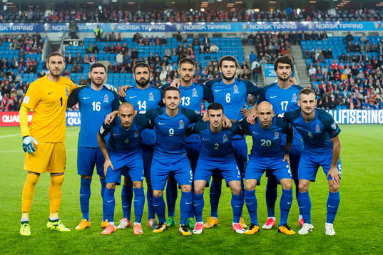 Azerbaijans starting eleven pose for a team photo, (top