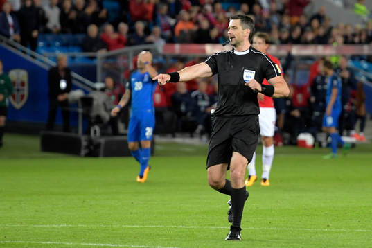 The referee Daniel Stefanski signals for a penalty for