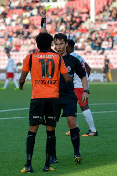 Senai Eyob Hagos of Åsane is shown a yellow card