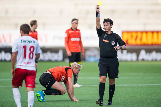 Ludvig Begby of Fredrikstad  is shown a yellow card by the