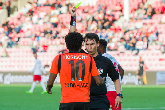 Senai Eyob Hagos of Åsane is shown a yellow card from by
