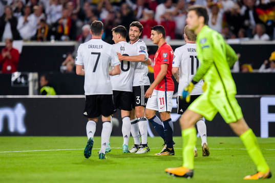Mesut Özil of Germany celebrates with teammate Jonas Hector
