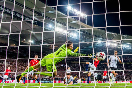 Mario Gomez of Germany scores 6-0 behind goalkeeper Rune