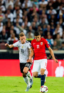Joshua Kimmich of Germany and Mohamed Elyounoussi of Norway