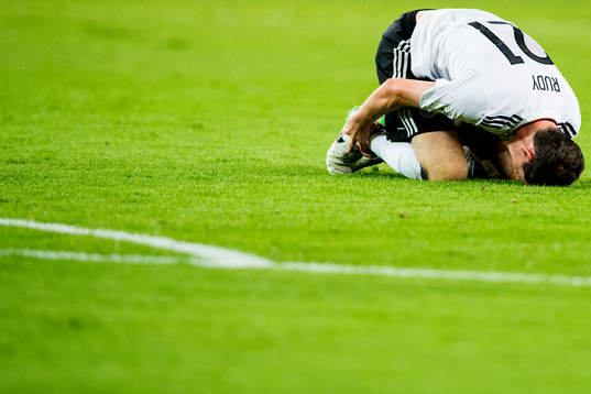Sebastian Rudy of Germany lies down