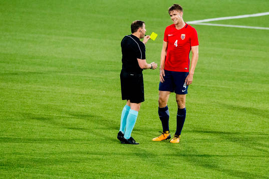 Kristoffer Ajer of Norway is shown a yellow card by referee