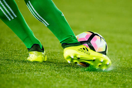 A goalkeeper kicks the ball