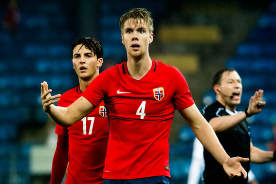 Rafik Zekhnini and Kristoffer Ajer of Norway react next to