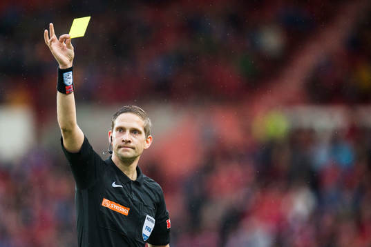 Espen Eskås, referee, awards a yellow card to Victor