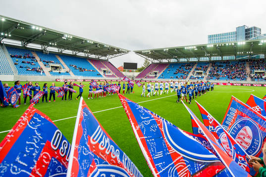 The teams enter the pitch