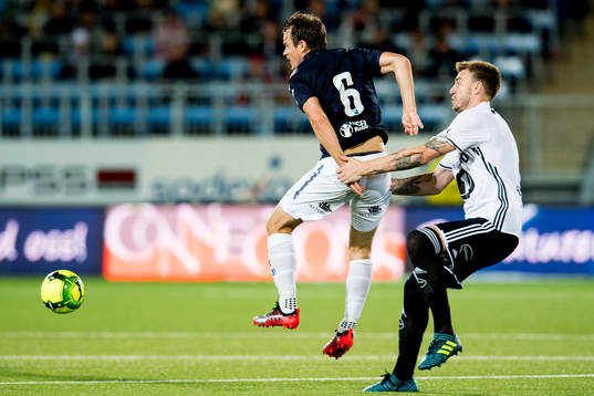 Henning Hauger of Strømsgodset and Nicklas Bendtner of