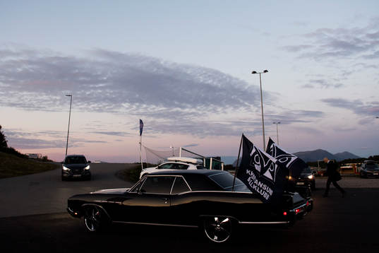 A car with flags of Kristiansund Ballklubb outside the arena
