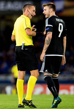 Referee Paolo Silvio Mazzoleni of Italy talks to Nicklas