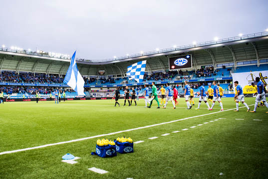 The two teams enter the field