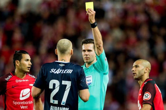 Nikita Baranov of Kristiansund is shown a yellow card by