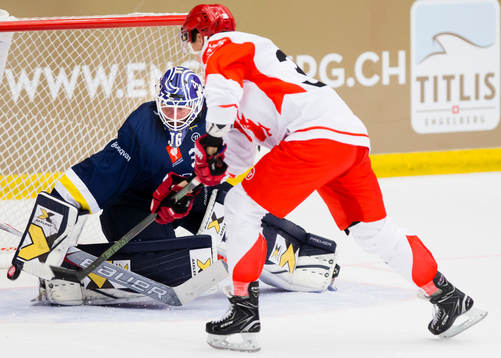 Goalkeeper Jonas Gunnarsson of HV71 stops Aron Chmielewski