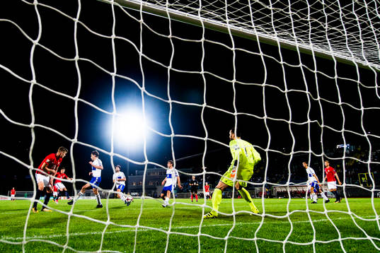 Martin Linnes of Norway scores 8-0 behind goalkeeper Aldo