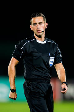 The referee Andrew Dallas of Scotland