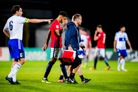 Joshua King of Norway walks off the pitch with an injury
