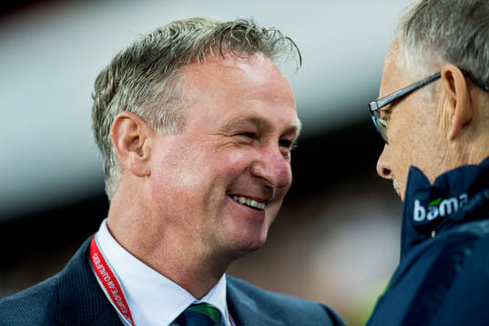 Michael O'Neill, head coach of Northern Ireland, talks to