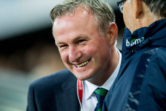 Michael O'Neill, head coach of Northern Ireland, talks to