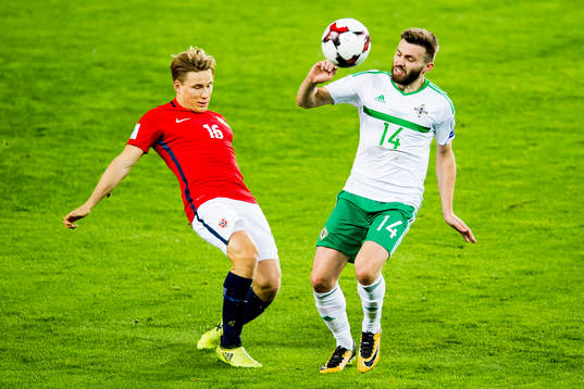Jonas Svensson of Norway and Stuart Dallas of Northern