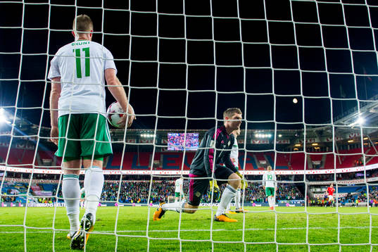 Chris Brunt and goalkeeper Michael McGovern of Northern