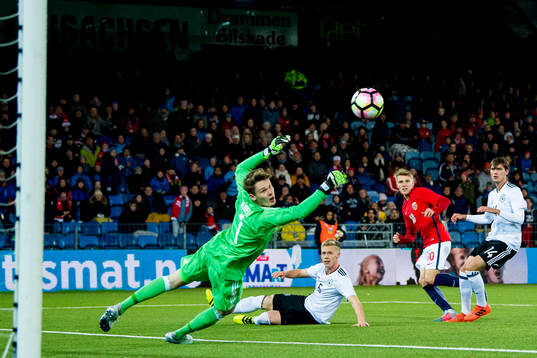 Martin Ødegaard of Norway scores 2-1 behind goalkeeper