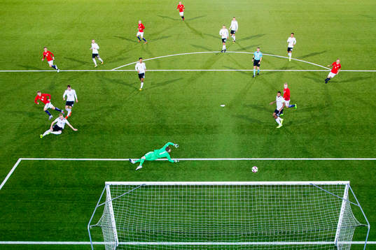 Martin Ødegaard of Norway scores 2-1 behind goalkeeper