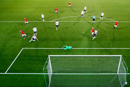 Martin Ødegaard of Norway scores 2-1 behind goalkeeper