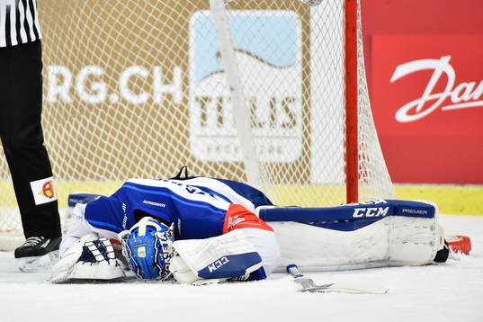Goalkeeper Karel Vejmelka gets tackled