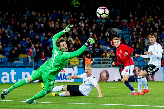 Martin Ødegaard of Norway scores 2-1 behind goalkeeper