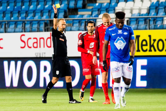 Kristoffer Barmen of Brann is shown the yellow card by Ola