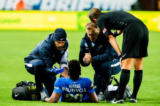 Thomas Olivier Amang Kegueni of Molde lies down injured
