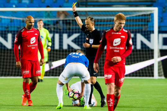Daniel Braaten of Brann is shown the yellow card by Ola