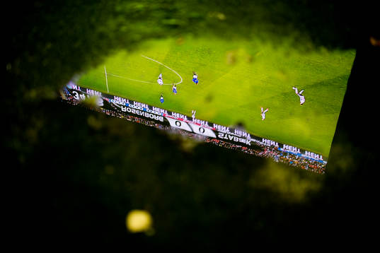The big screen at Lerkendal stadion seen through a puddle