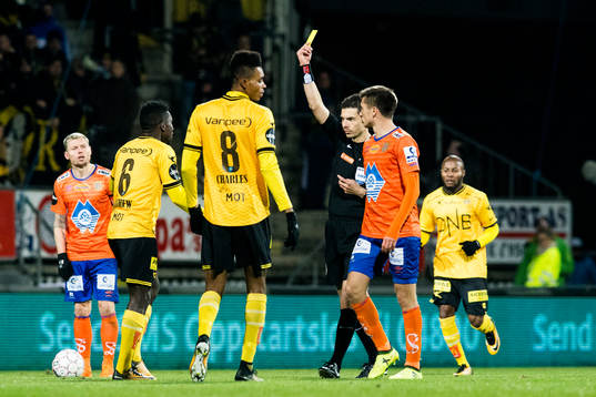 Tore Hansen, referee, gives a yellow card to Ifeanyi