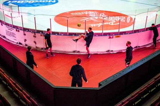 Players of Adler Mannheim practice football
