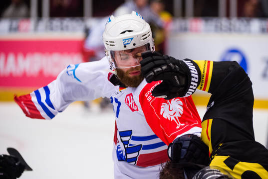 Thomas Larkin of Adler Mannheim fights Lukas Kilström of